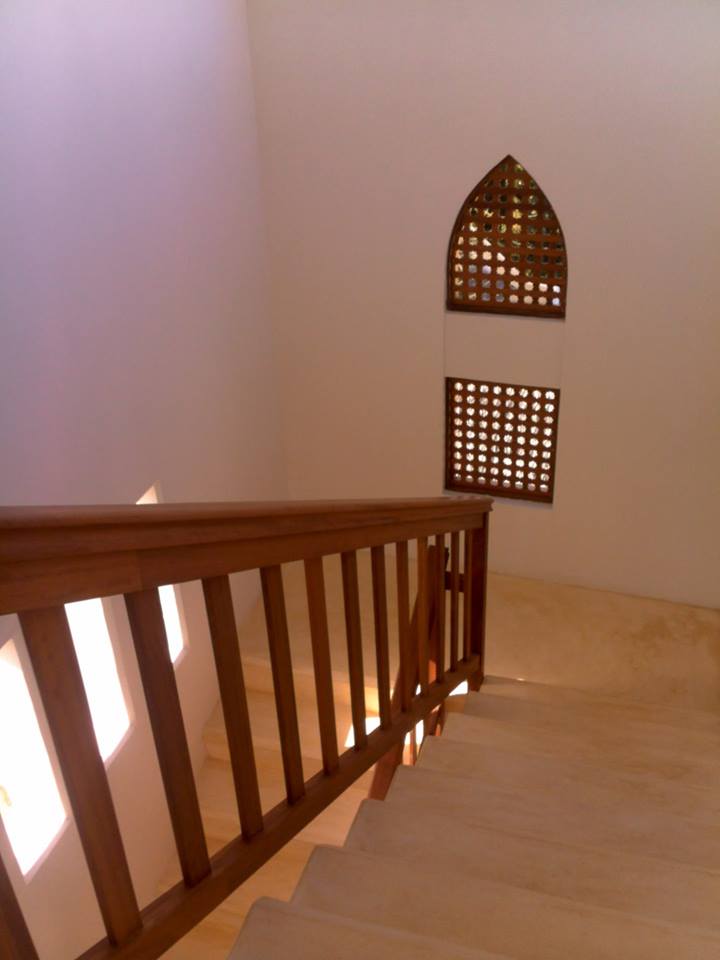 Bespoke timber staircase railing and carved Swahili lattice window